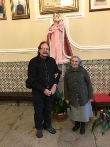 Standing with nun Felicidade (“Happiness”) in front of a rare “12-year-old” Jesus statue