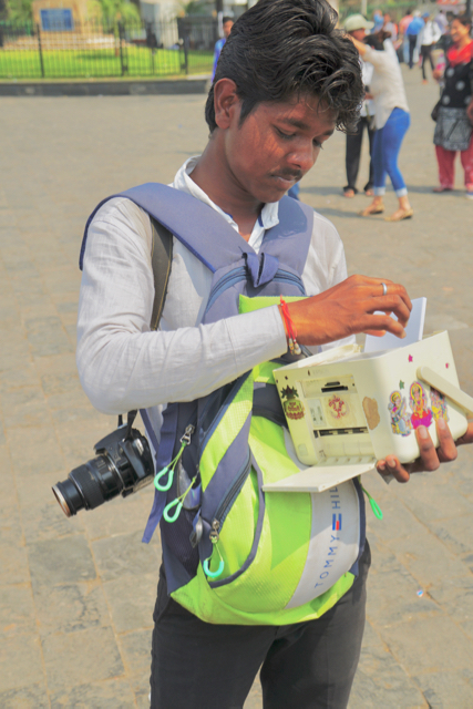 This enterprising young man takes photos of tourists and then immediately prints them out on his battery-operated printer.