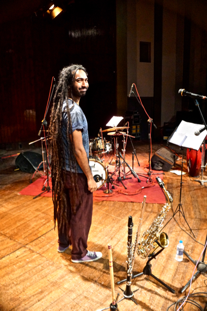 Indian percussionist Anand, showing off his twelve years of braided locks