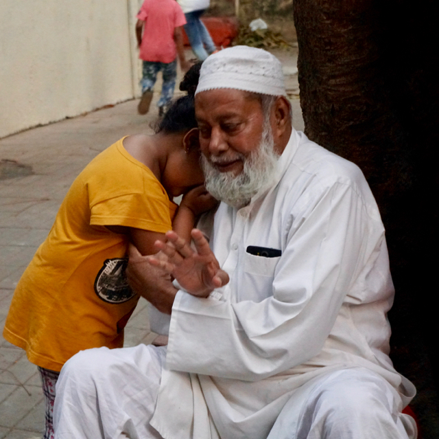 This Muslim man has the kindest face. Here, he comforts his granddaughter. He lives above Bandra Base.