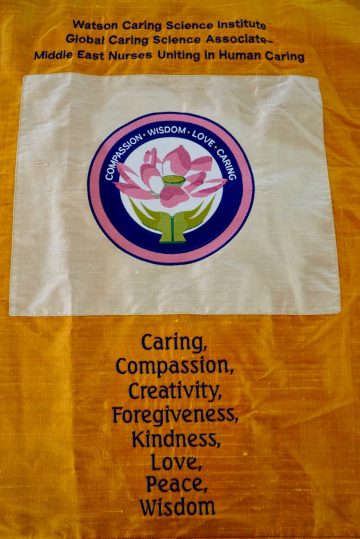 Conference banner listing the values of Caritas